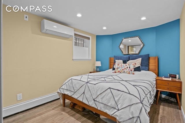 bedroom featuring baseboard heating, an AC wall unit, recessed lighting, baseboards, and wood finished floors