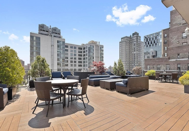 148 E 24th St Unit 15C, New York City, NY 10010 - wooden deck with outdoor dining area, an outdoor hangout area, and a city view