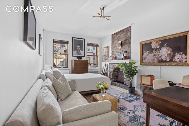 335 W 21st St Unit 3Re, New York City, NY 10011 - bedroom with a fireplace, wood finished floors, and a chandelier