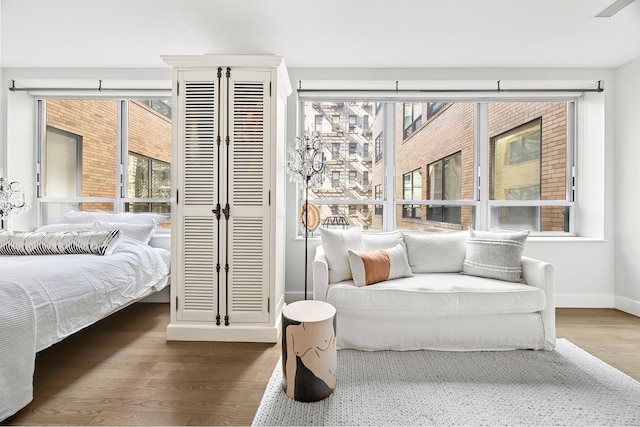 bedroom featuring wood finished floors and baseboards