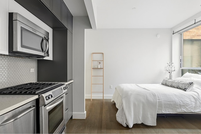 bedroom featuring dark wood-type flooring and baseboards