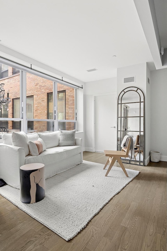 living room featuring wood finished floors, plenty of natural light, and baseboards