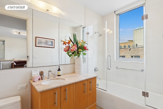 full bath with bath / shower combo with glass door, vanity, toilet, and visible vents