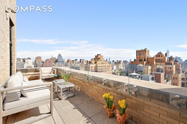 view of patio featuring a balcony and a city view