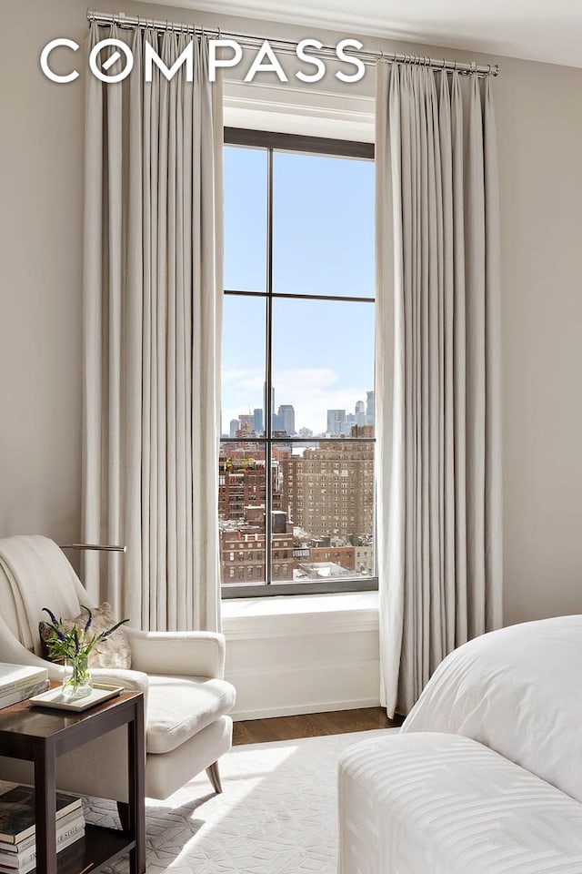 212 W 18th St Unit 14A, New York City, NY 10011 - bedroom with wood finished floors, a view of city, and baseboards