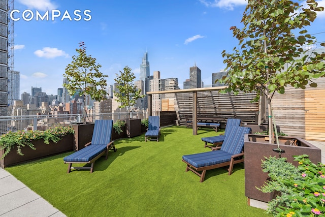 view of yard with a view of city and fence