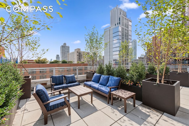 view of patio / terrace featuring outdoor lounge area and a city view