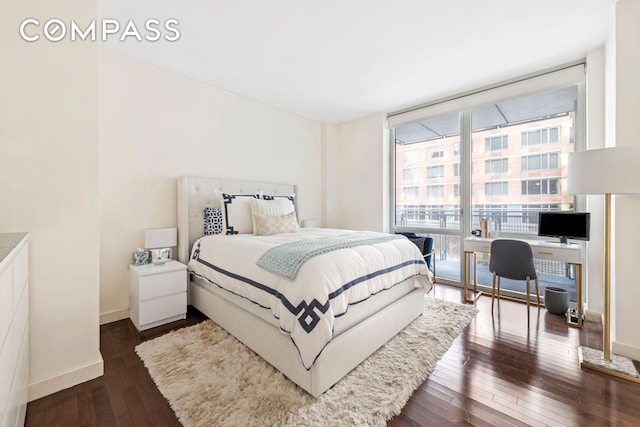 bedroom featuring baseboards, floor to ceiling windows, and dark wood-style floors