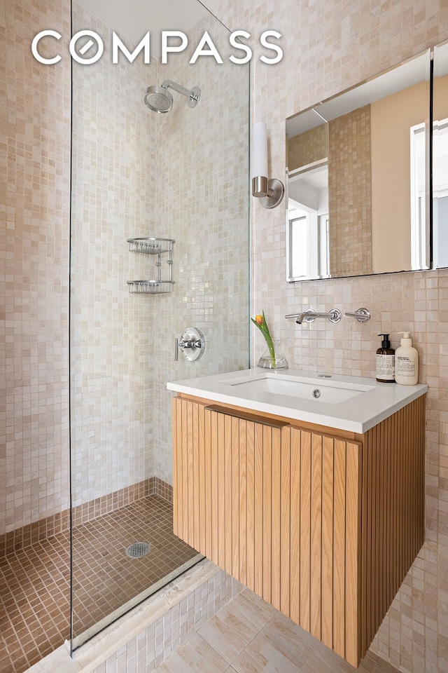 3 Hanover Sq Unit 7D, New York City, NY 10004 - full bath featuring tile walls, tiled shower, and vanity