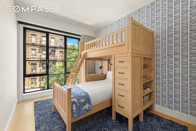 bedroom featuring baseboards and wood finished floors