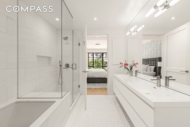 bathroom featuring ensuite bathroom, double vanity, a sink, and a shower stall
