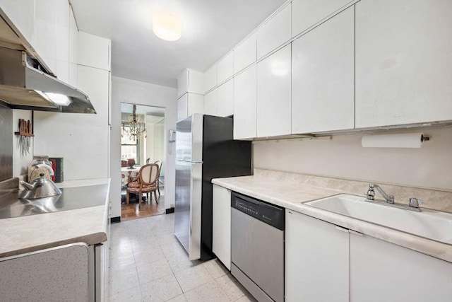 kitchen featuring light countertops, appliances with stainless steel finishes, and white cabinetry