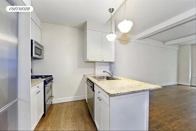 40 W 72nd St Unit 62, New York City, NY 10023 - kitchen with stainless steel appliances, a sink, a peninsula, dark wood-style floors, and white cabinetry