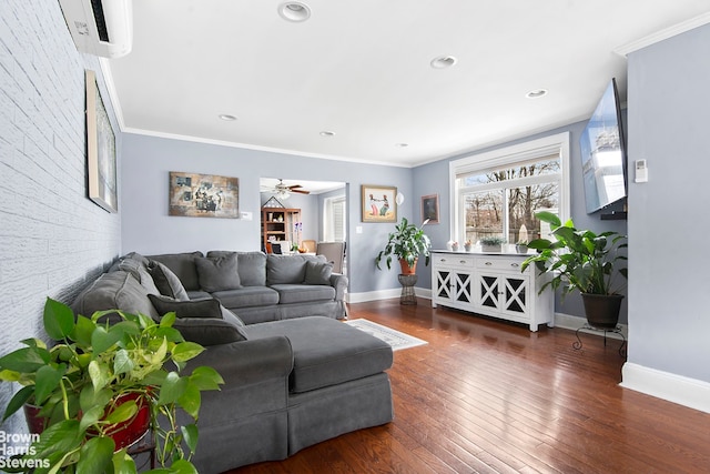 living area with a ceiling fan, baseboards, ornamental molding, and wood finished floors