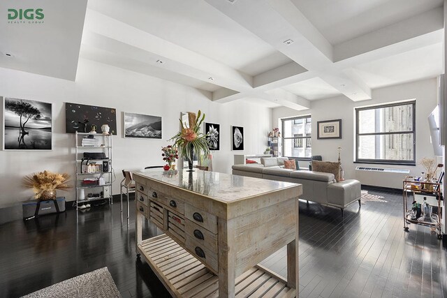 kitchen with dark wood-style flooring, a kitchen island, beamed ceiling, baseboards, and coffered ceiling