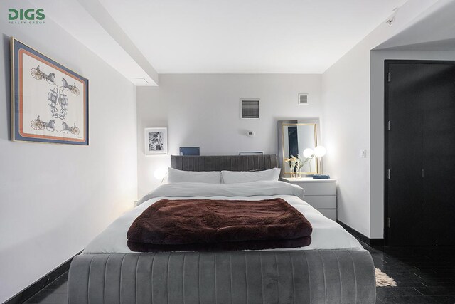 bedroom with baseboards and visible vents