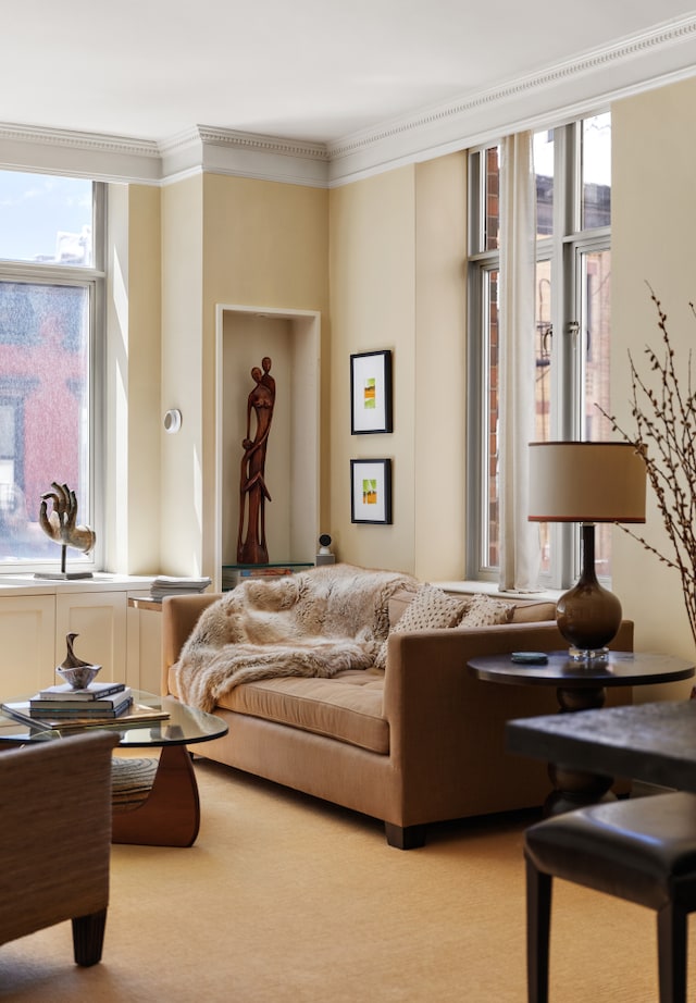 living area featuring crown molding