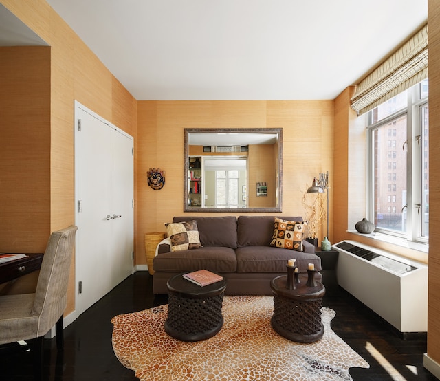 201 W 17th St Unit 4C, New York City, NY 10011 - living area featuring dark wood-style flooring and radiator heating unit