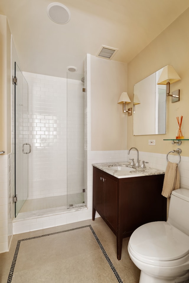 full bath with visible vents, a stall shower, toilet, and vanity