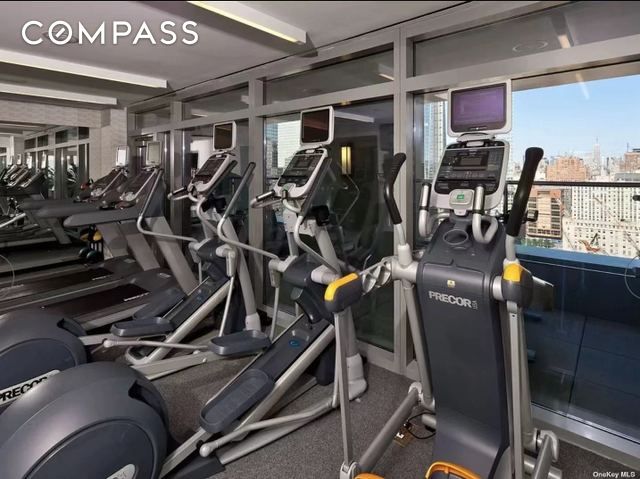 123 Washington St Unit 52F, New York City, NY 10006 - exercise room with plenty of natural light