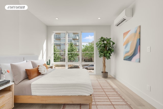 166 Washington Ave Unit 4A, New York City, NY 11205 - bedroom with a wall mounted air conditioner, light wood-style floors, recessed lighting, and baseboards