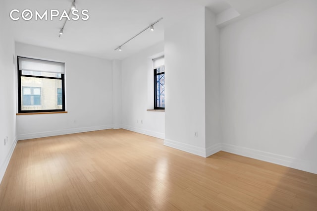 110 Livingston St Unit 9P, New York City, NY 11201 - spare room with track lighting, light wood finished floors, and baseboards