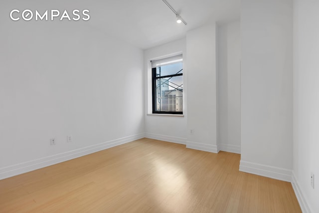 110 Livingston St Unit 9P, New York City, NY 11201 - spare room featuring light wood finished floors, track lighting, and baseboards