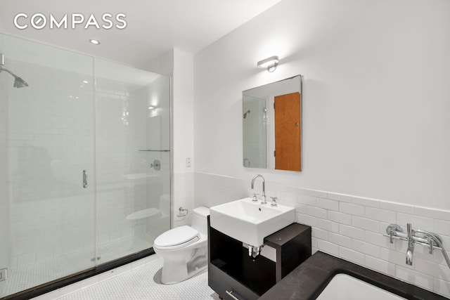 110 Livingston St Unit 9P, New York City, NY 11201 - full bathroom featuring tile walls, toilet, a stall shower, a wainscoted wall, and vanity