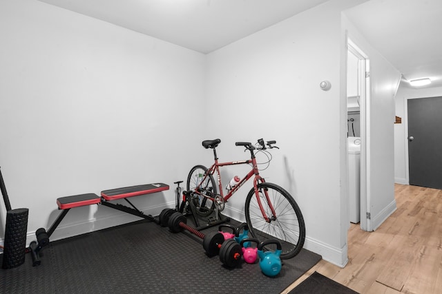 workout room featuring baseboards and wood finished floors