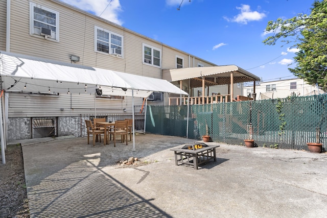 view of patio with a fire pit and fence