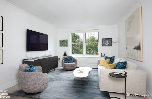 living room featuring baseboards, ornamental molding, and wood finished floors