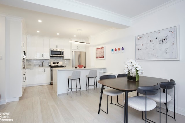 64 E 94th St Unit 4C, New York City, NY 10128 - dining room with light wood-style flooring, ornamental molding, and recessed lighting