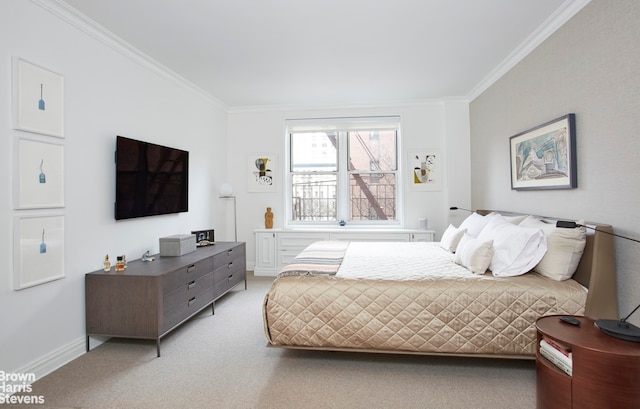 bedroom with crown molding, baseboards, and light colored carpet
