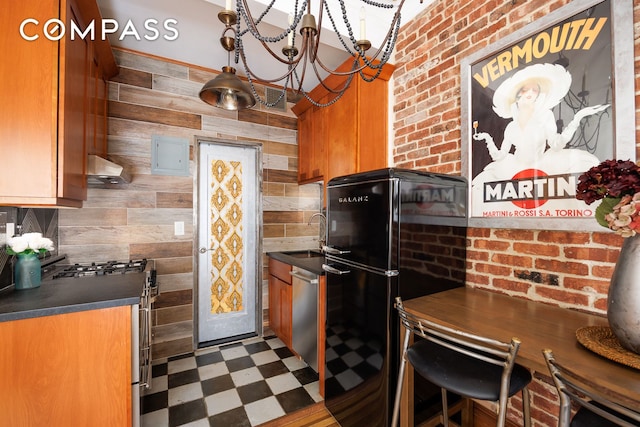 331 W 89th St Unit 2B, New York City, NY 10024 - kitchen featuring stainless steel appliances, tile patterned floors, dark countertops, a chandelier, and brown cabinetry