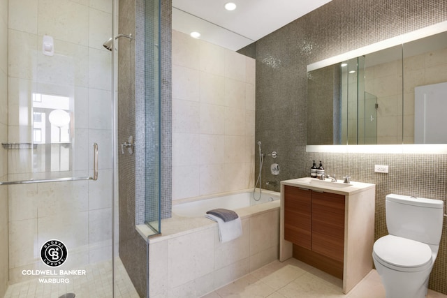 full bath with tile patterned floors, a stall shower, and tile walls