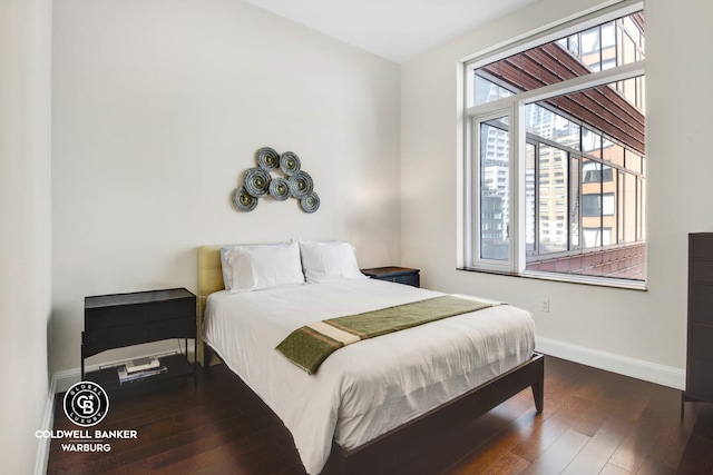 bedroom with baseboards and hardwood / wood-style flooring