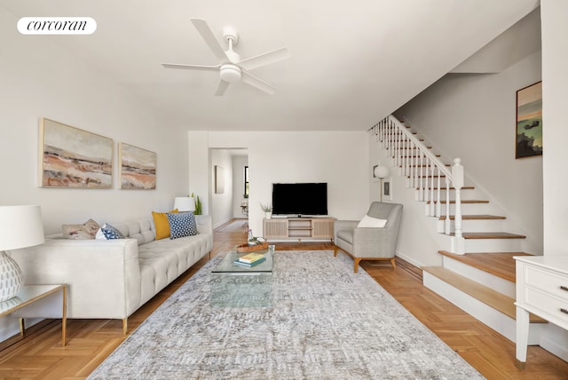 living area featuring visible vents, baseboards, ceiling fan, and stairway
