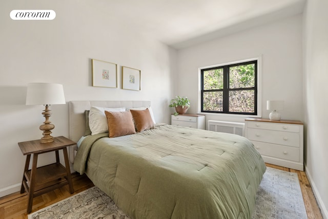 bedroom featuring light wood-style floors and baseboards