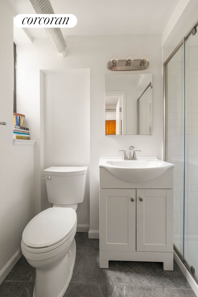 bathroom featuring vanity, baseboards, toilet, and a shower stall
