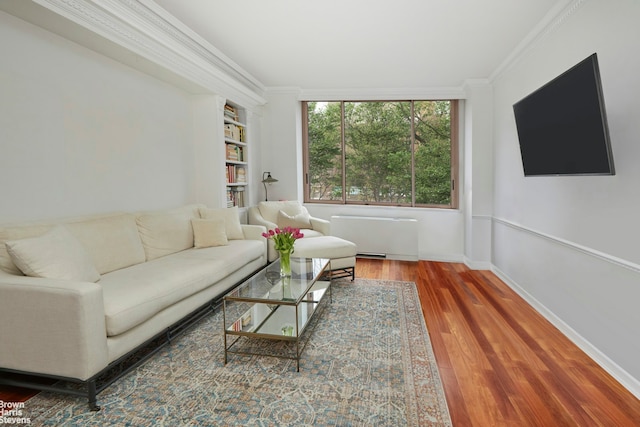 101 W 79th St Unit 2G, New York City, NY 10024 - living area with radiator heating unit, ornamental molding, wood finished floors, and built in shelves