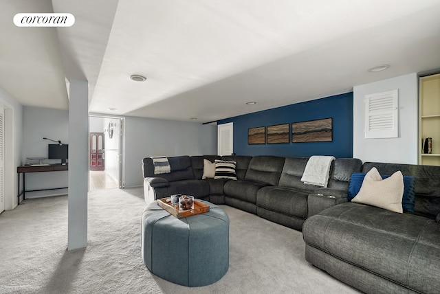 carpeted living area featuring visible vents