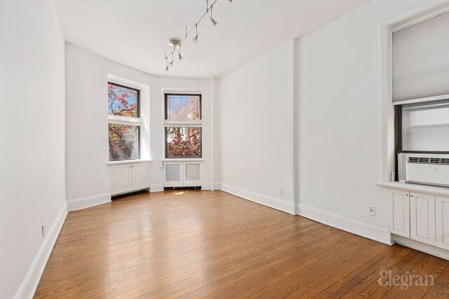 175 Amity St Unit A4, New York City, NY 11201 - empty room with wood finished floors, baseboards, and cooling unit