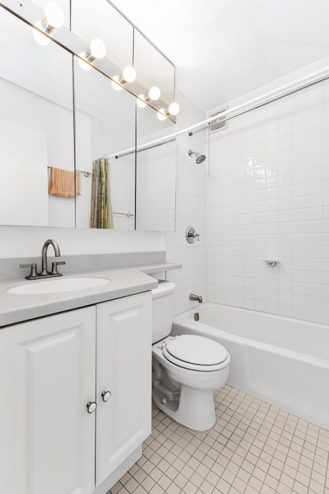 bathroom featuring toilet, tile patterned floors, shower / bath combo, and vanity