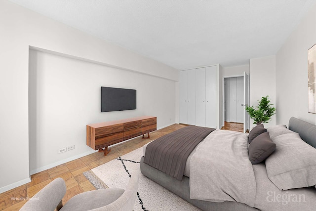 bedroom with baseboards and a closet