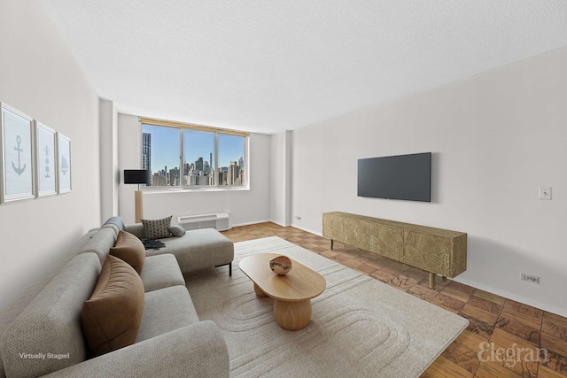 living room with baseboards and a textured ceiling