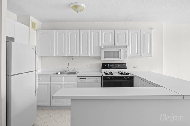 kitchen featuring a sink, white cabinetry, and white appliances