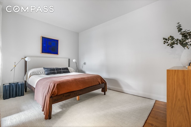 245 10th Ave Unit 2W, New York City, NY 10001 - bedroom featuring baseboards and wood finished floors