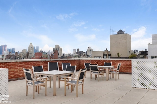 view of patio featuring a view of city and outdoor dining space