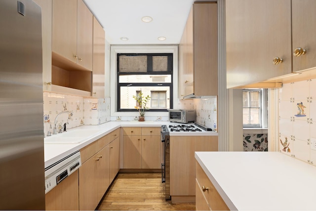 1165 Park Ave Unit 10A, New York City, NY 10128 - kitchen featuring a sink, stainless steel refrigerator, light brown cabinetry, light countertops, and recessed lighting