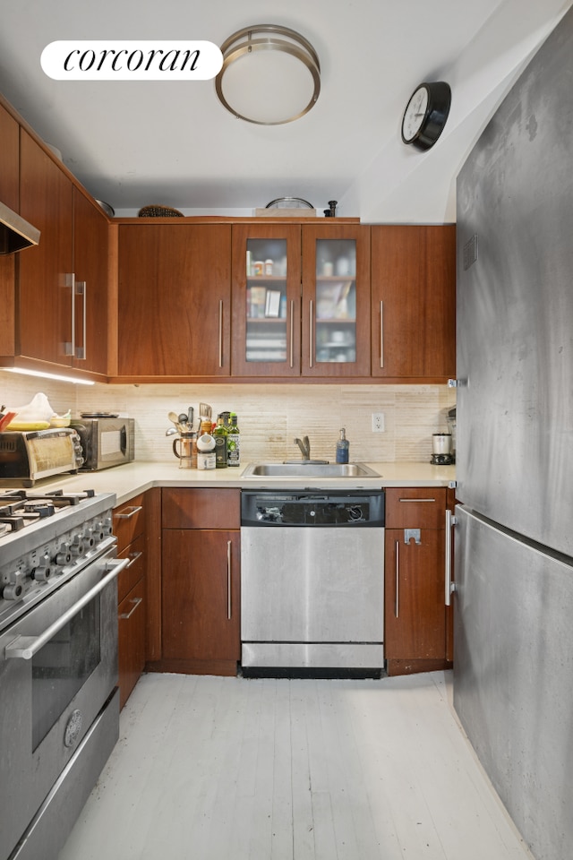 502 1st St Unit 1, New York City, NY 11215 - kitchen with stainless steel appliances, light countertops, backsplash, and brown cabinets